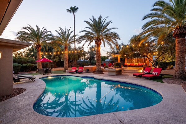 Sparkling pool, hot tub, sun loungers, gazebo, firepit, BBQ, cornhole, and ample seating.