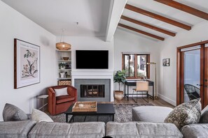 Relax in a bright, airy space with vaulted ceilings and water views