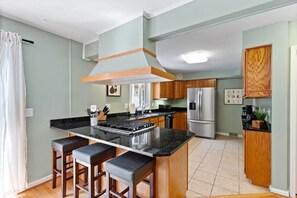 Large and functional kitchen, fully stocked with the essentials.
