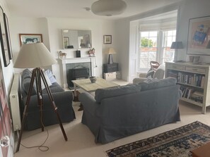 Sitting room with bay window with coastal views