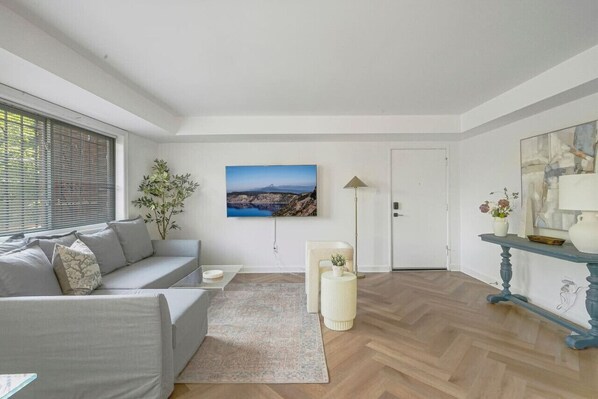 Light-filled south-facing spacious living room with pull out queen sofa bed