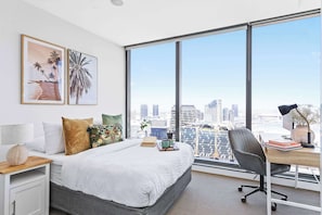 The master bedroom with a queen sized bed & plush pillows.