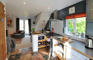 Kitchen with range cooker and cooker hood, microwave, kettle