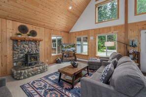 Cozy chalet living space boasts of open concept with the kitchen and dining area