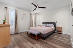 Comfortable bed in the master bedroom with a TV, private bathroom and big closet