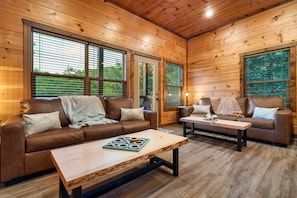 Rustic cabin with cozy sofas—unwind after a day in the Smoky Mountains.