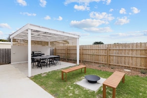 Enjoy alfresco dining under the pergola with a built-in BBQ and outdoor seating