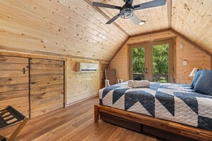 Retreat to our serene primary master bedroom with a comfy queen bed, private balcony access, and modern amenities including a ceiling fan, mini split AC, and en suite bathroom.