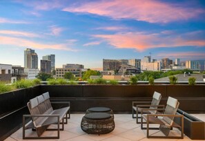 Our building's shared rooftop amenity space features plenty of outdoor seating and a beautiful view of the city.