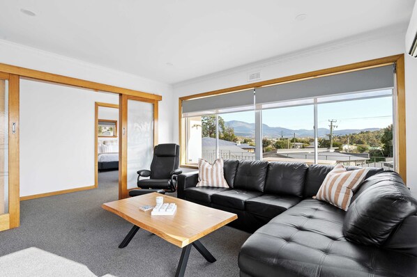Main Lounge with smart TV and air conditioner.