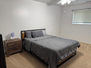 This bedroom offers all the essentials for a comfortable and restful stay. It features a cozy bed, a convenient nightstand, and a spacious wardrobe/closet—everything you need to feel right at home from the moment you arrive.
