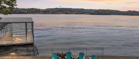 Serene lakeside gatherings with a cozy fire pit and stunning sunset views.