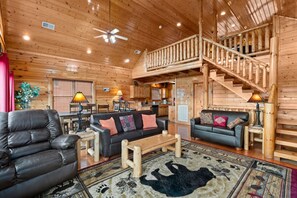 Newly updated furniture completes the cozy living room. The stairs lead to the game room upstairs. The second bedroom and lounge/theater area are located downstairs.