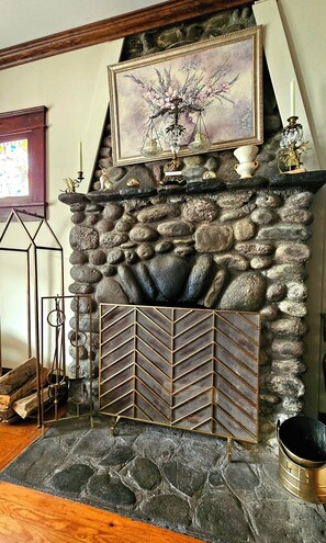river rock wood burning fireplace in living room 