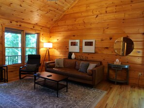 Cozy living room with smart TV and Bluetooth sound bar for relaxing.