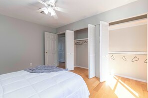 Spacious closet in bedroom with hangers-on.
