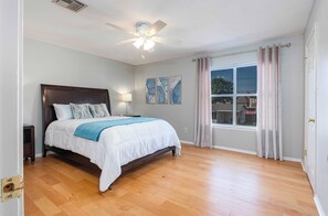 The spacious master bedroom has a queen bed and a walk-in closet.
