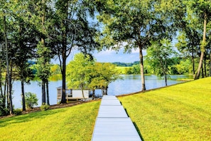 Stroll down a private walkway to your secluded dock, offering serene lake access and peaceful nature views