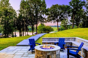 Relax by the fire pit with scenic lake views, perfect for cozy evenings and outdoor gatherings