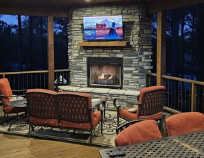 Outdoor Living Space: Gather around the stunning stone fireplace and enjoy movie nights under the stars!