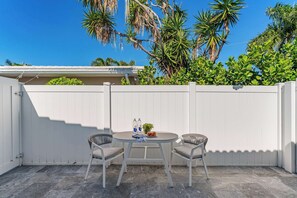 Outdoor seating for two with a table, creates the ideal space for a peaceful meal or quiet conversation under the open sky.