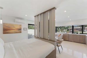 Experience the perfect blend of openness and comfort with a spacious room that includes a plush king bed for a restful night’s sleep.