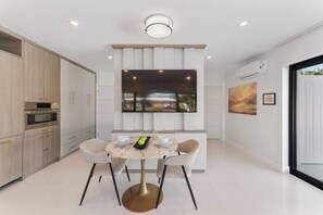Dine for two in style, with a smart TV nearby for the perfect blend of dining and relaxation.