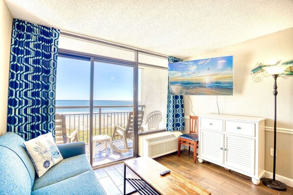 This beautiful oceanfront living room is perfect for relaxing on a sunny vacation day.   Sit on the plush full-sized couch with sofa sleeper (queen) and stream your favorite apps or channels on the 50" Smart TV.  Walk out on the oceanfront balcony.