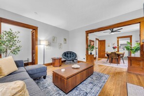 As you enter, you’ll find eye-catching woodwork and shiny hardwood floors throughout