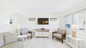 Living area with comfortable furnishings TV and balcony access