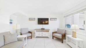 Living area with comfortable furnishings TV and balcony access