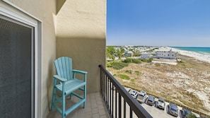 Primary bedroom balcony with seating and coastal views
