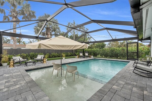 Outdoor Oasis: Refresh in your private pool surrounded by lush greenery and sunny skies!