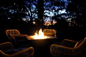 The cozy fire pit on the back patio is the perfect spot for evening relaxation. 