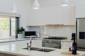 The kitchen boasts generous amenities
