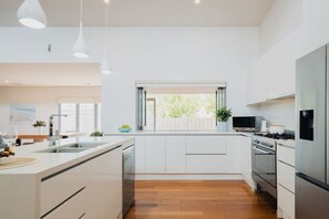Kitchen opens to outdoor bar