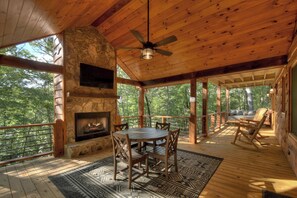 Sitting area on the porch with a seasonal gas fireplace 
