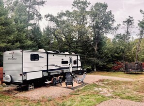 Modern camper with fire pit. Firewood provided onsite