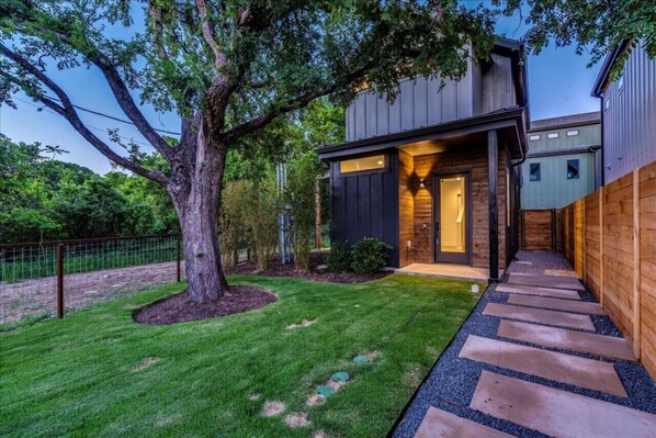 Enjoy a peaceful backyard setting with a lush tree enhancing the tranquil environment.