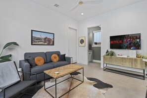 Bright and airy open living space designed for comfort and gatherings, with stylish furnishings.