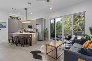 Spacious open concept living area that blends the living room, dining space, and kitchen for seamless entertaining.