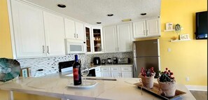 Spacious and completely remodeled kitchen with easy-to-clean quartz counter top