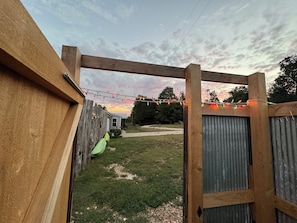 Looking out of the outdoor shower shack towards the house