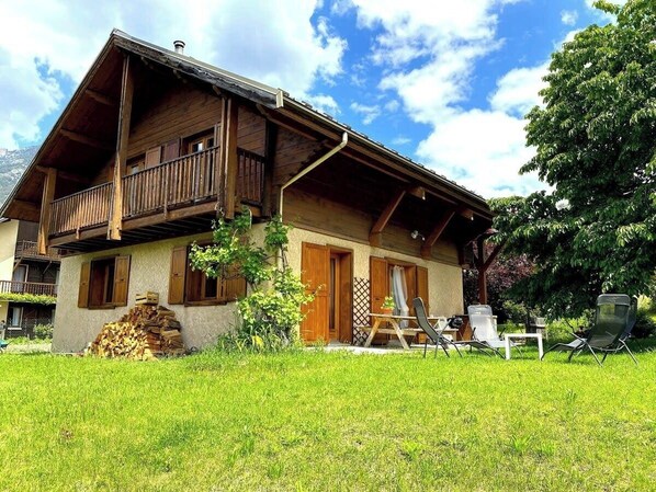 Step outside and enjoy the fresh mountain air on the expansive lawn, complete with a charming patio set and a wood-burning stove for cozy evenings. The chalet is situated on a quiet street, offering peace and privacy while remaining just a stone's throw f