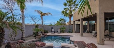 Hot tub and pool with waterfall feature