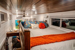 Cozy queen bed with mounted fan and SMART TV to enjoy a movie together!
