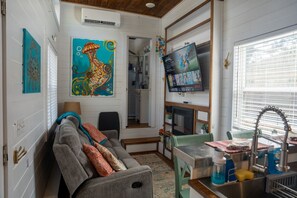 Local artist painting of jellyfish and smart TV and electric fireplace for warmth or ambiance