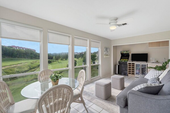 Enclosed Sun Room with ample seating, futon, dining table, and view