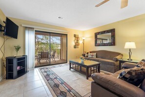 Bright living area with queen sofa sleeper, and Smart TV