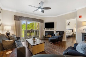 Floor-to-ceiling sliding glass doors in the living area